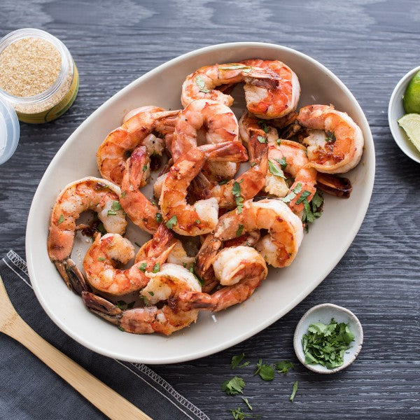 Plated dish with rolled and sliced food items on a marble surface, with salt and pepper shakers in the background.